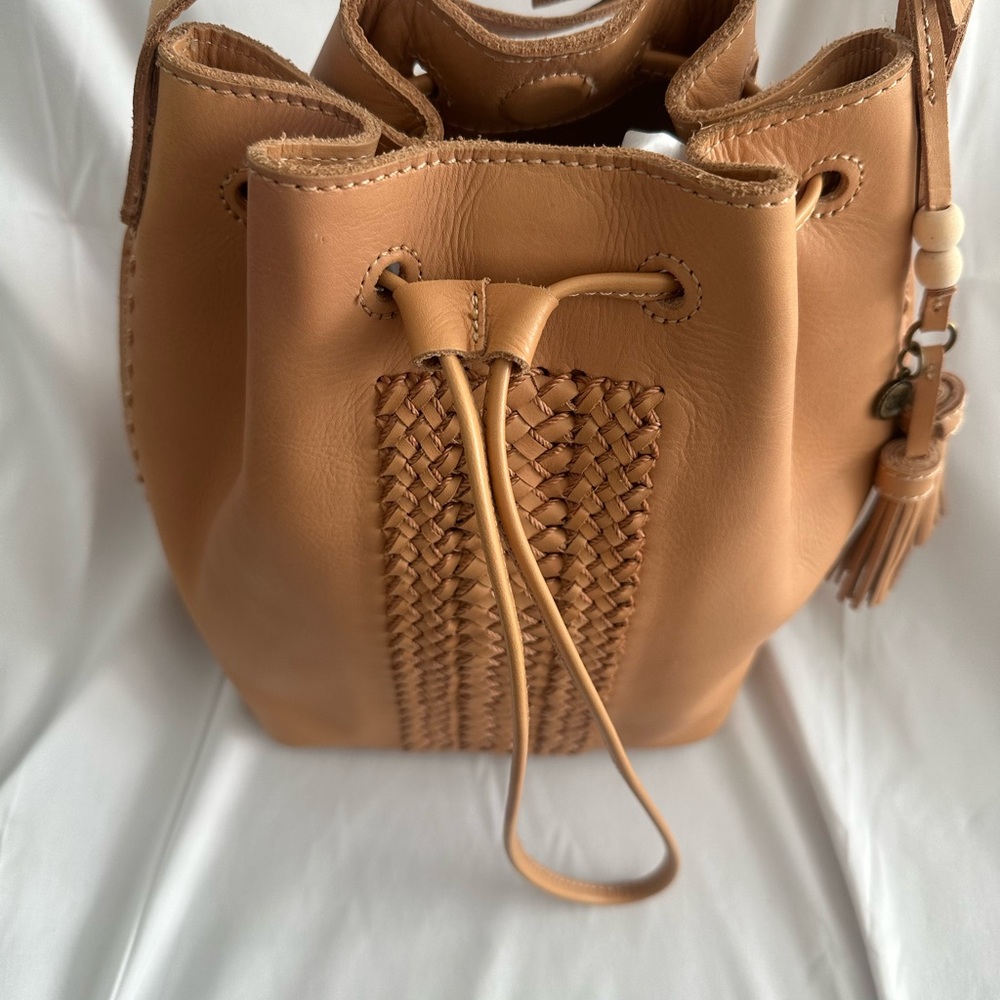 The Sak - woven, hand-stitch details define this bucket bag.